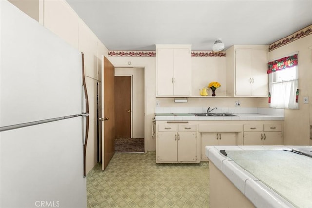 kitchen featuring sink and white fridge