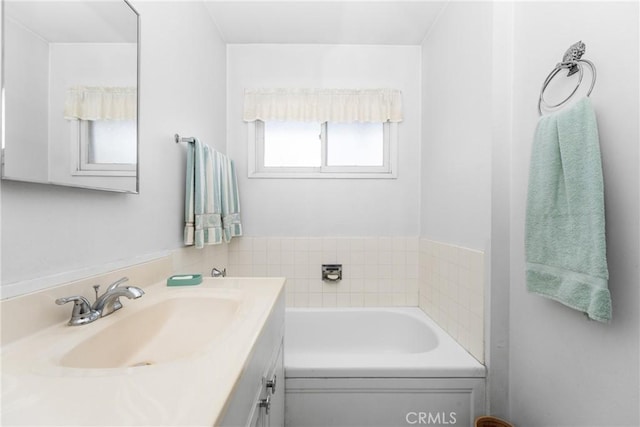 bathroom with a bath and vanity