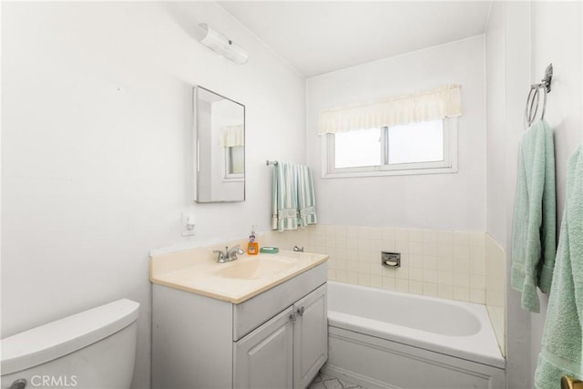 bathroom featuring vanity, toilet, and a tub