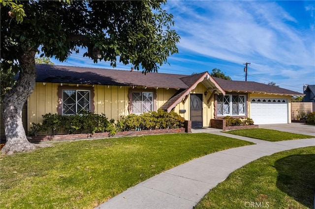 single story home featuring a front yard and a garage