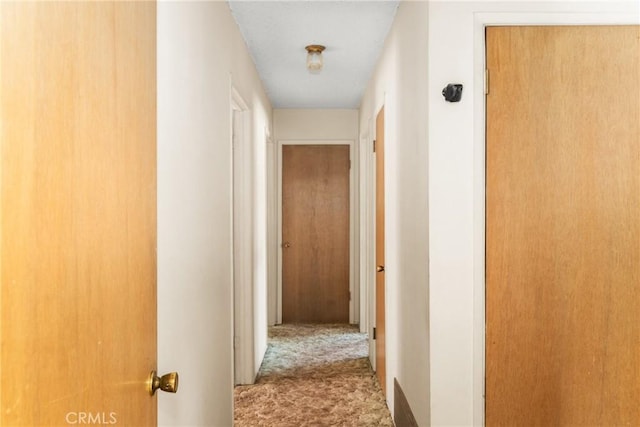 corridor with carpet flooring