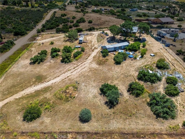 birds eye view of property with a rural view