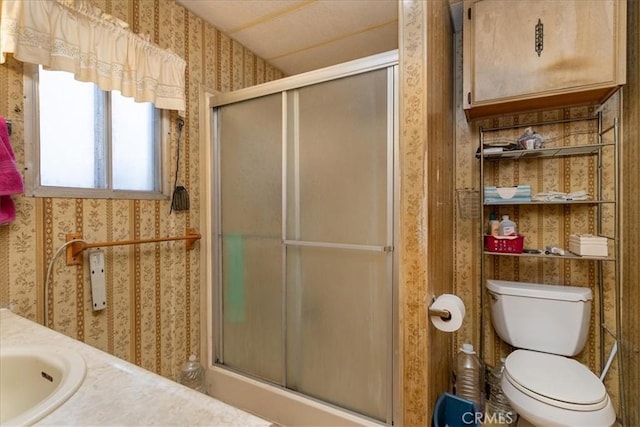 bathroom featuring vanity, toilet, and walk in shower