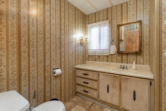 bathroom featuring vanity and toilet