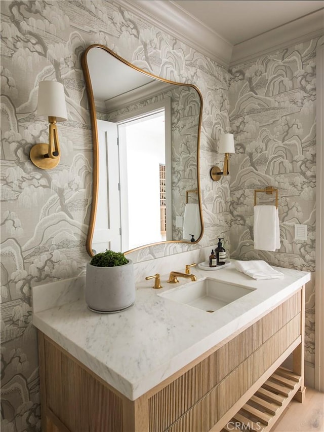 bathroom featuring vanity, wood-type flooring, and ornamental molding