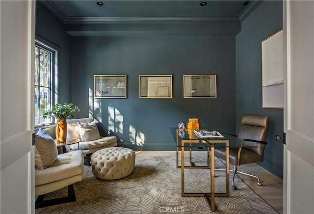 sitting room with hardwood / wood-style floors and ornamental molding