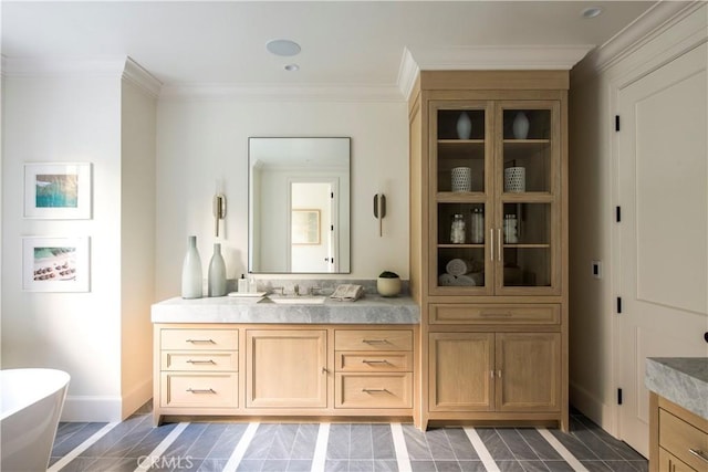 bathroom featuring a tub to relax in, crown molding, and vanity