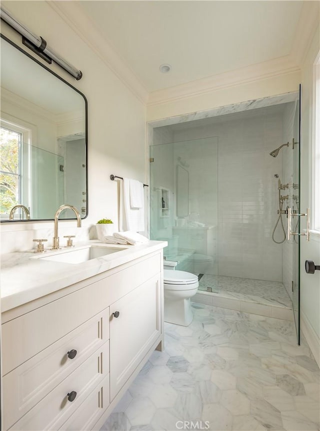 bathroom featuring a shower with shower door, toilet, ornamental molding, and vanity