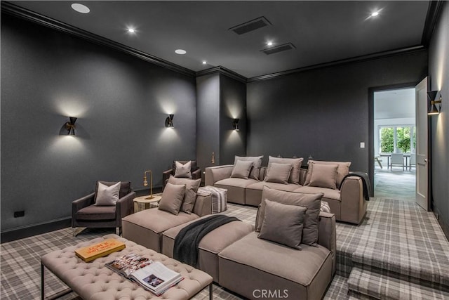 carpeted home theater featuring crown molding