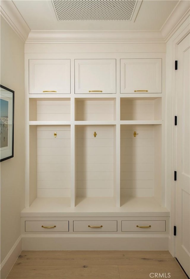 mudroom with light wood-type flooring and ornamental molding