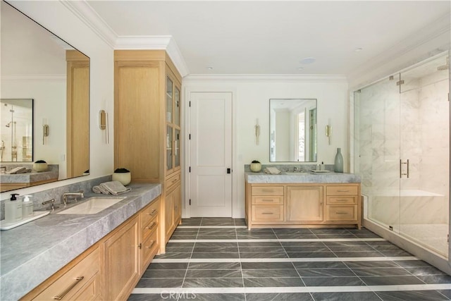 bathroom featuring vanity, a shower with shower door, and ornamental molding