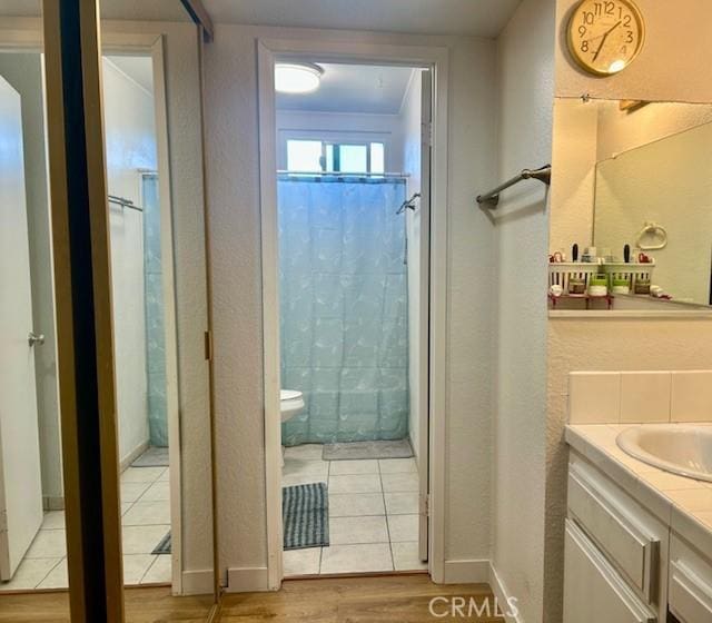 bathroom with walk in shower, ornamental molding, vanity, hardwood / wood-style flooring, and toilet