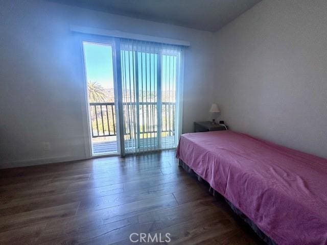 bedroom featuring access to outside and dark wood-type flooring