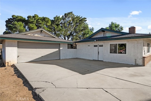 ranch-style home with french doors and a garage