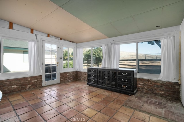 unfurnished sunroom with vaulted ceiling