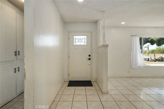 tiled entryway with a wealth of natural light