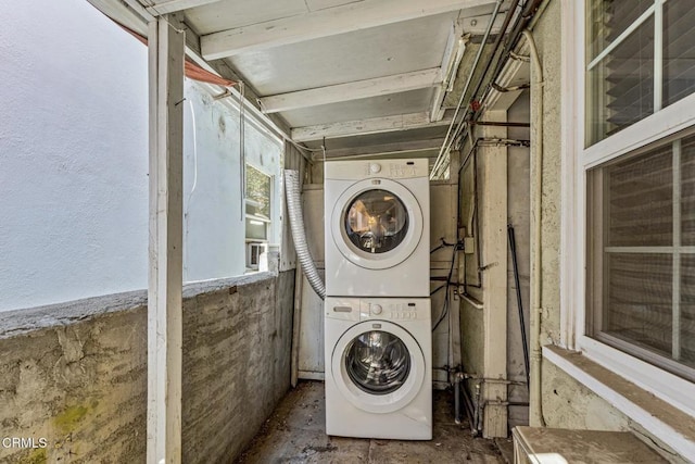 laundry room featuring stacked washer and clothes dryer