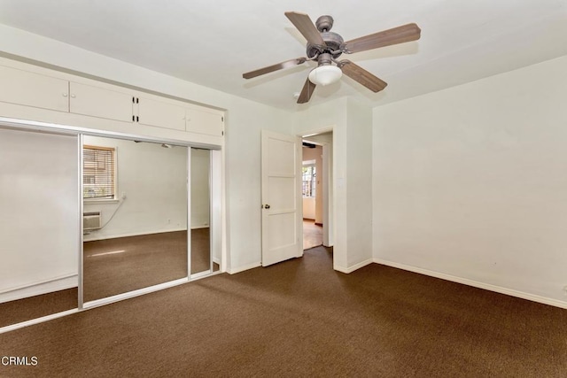 unfurnished bedroom featuring ceiling fan, an AC wall unit, and a closet