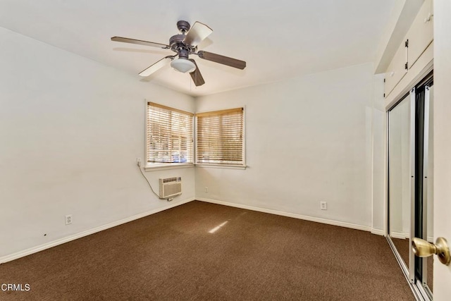 unfurnished bedroom featuring a wall unit AC, ceiling fan, a closet, and dark colored carpet