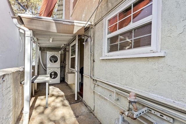 exterior space with stacked washing maching and dryer