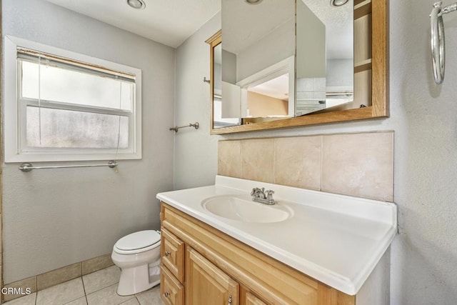 bathroom with tile patterned floors, vanity, and toilet