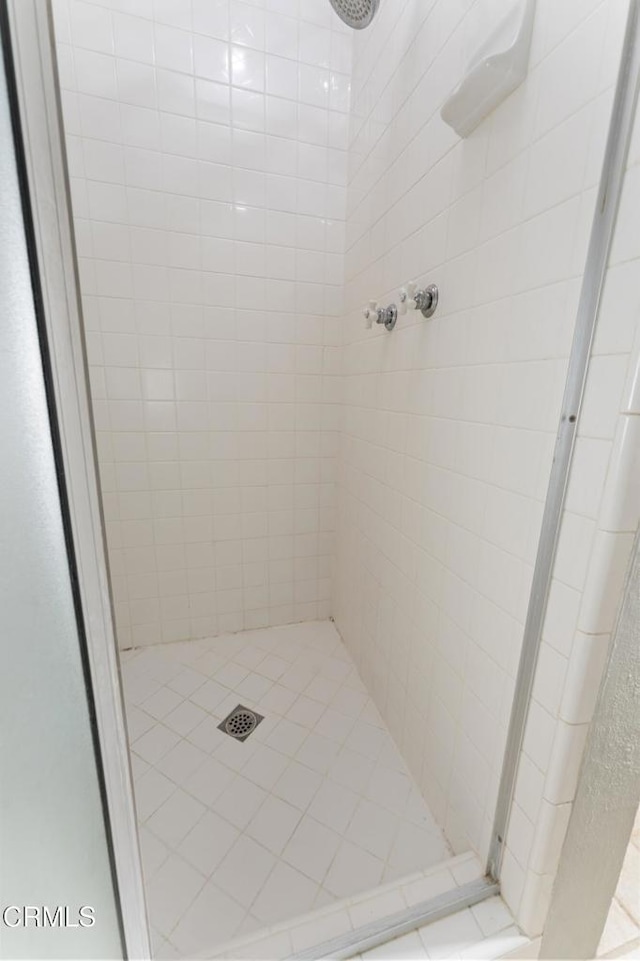 bathroom with tiled shower