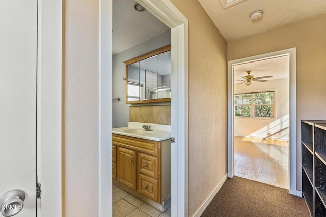 bathroom featuring ceiling fan, tile patterned floors, and vanity