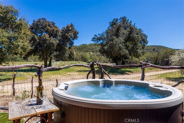 view of swimming pool featuring a hot tub