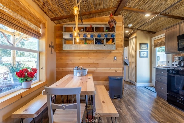 dining room with lofted ceiling, wooden ceiling, wooden walls, dark hardwood / wood-style floors, and a wealth of natural light