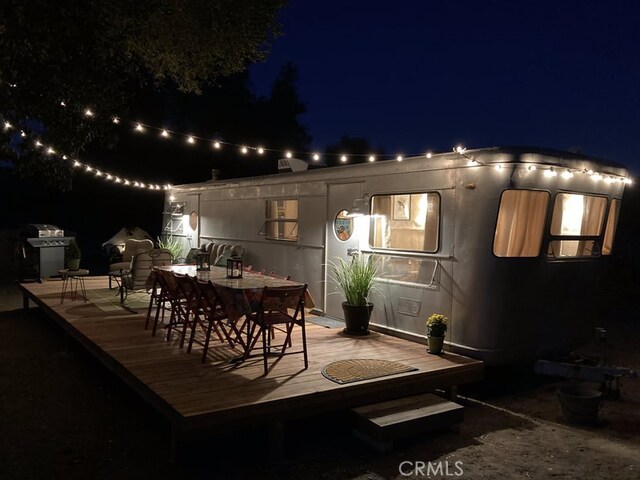 exterior space with a wooden deck and area for grilling