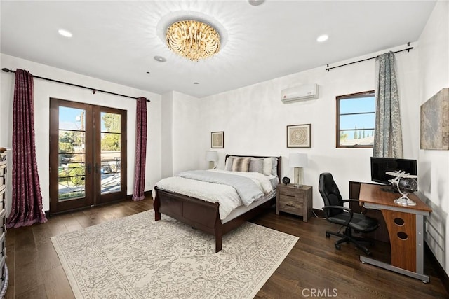 bedroom with dark hardwood / wood-style floors, access to exterior, a wall unit AC, and french doors