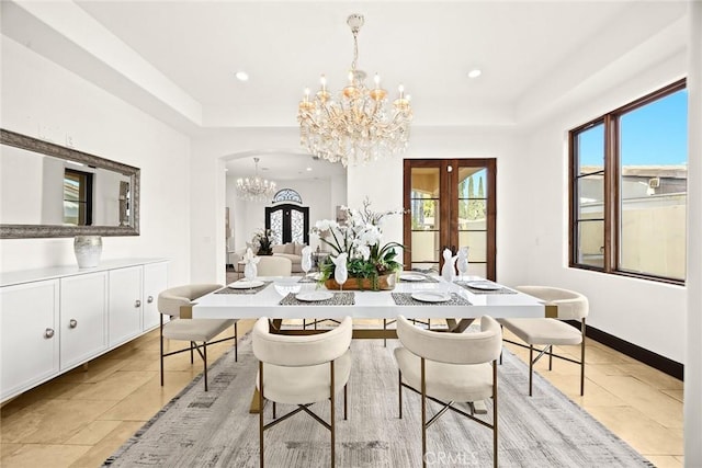 dining area featuring french doors and an inviting chandelier