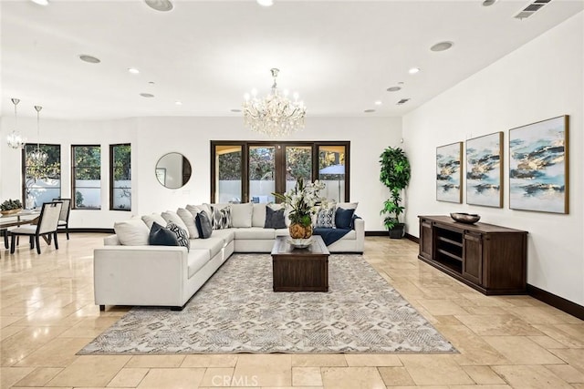 living room featuring a notable chandelier, a wealth of natural light, and french doors