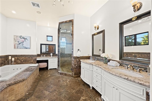 bathroom with vanity and independent shower and bath