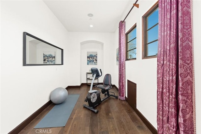 exercise room with dark wood-type flooring