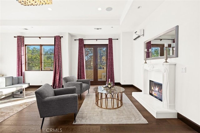 living room with dark hardwood / wood-style flooring and french doors