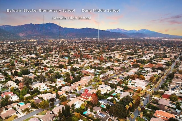 aerial view at dusk featuring a mountain view