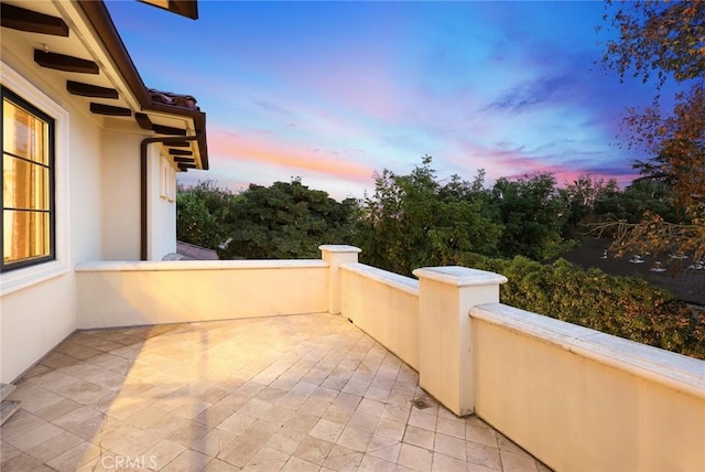 patio terrace at dusk with a balcony