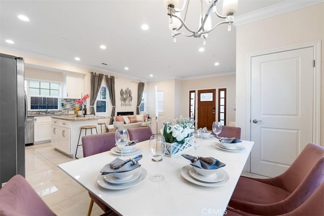 dining space with crown molding and a chandelier