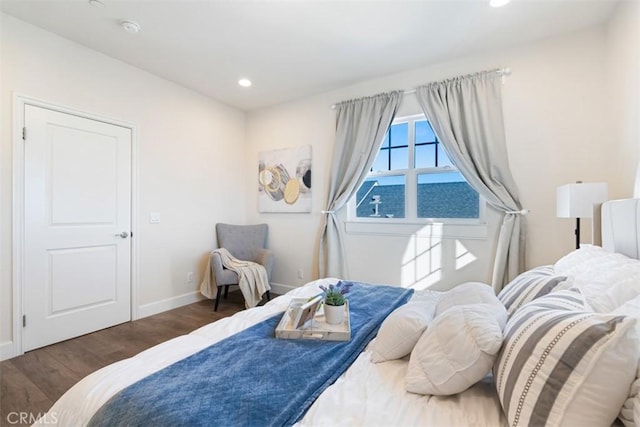 bedroom with dark hardwood / wood-style floors