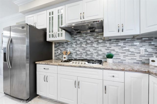 kitchen featuring white cabinets, decorative backsplash, light stone countertops, and stainless steel appliances