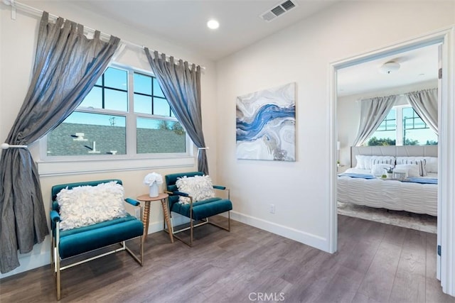 sitting room featuring hardwood / wood-style flooring and a healthy amount of sunlight