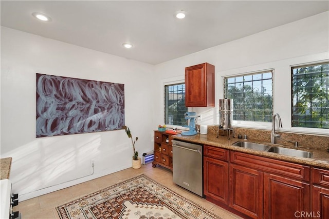 kitchen featuring dishwasher, light tile patterned flooring, light stone countertops, and sink