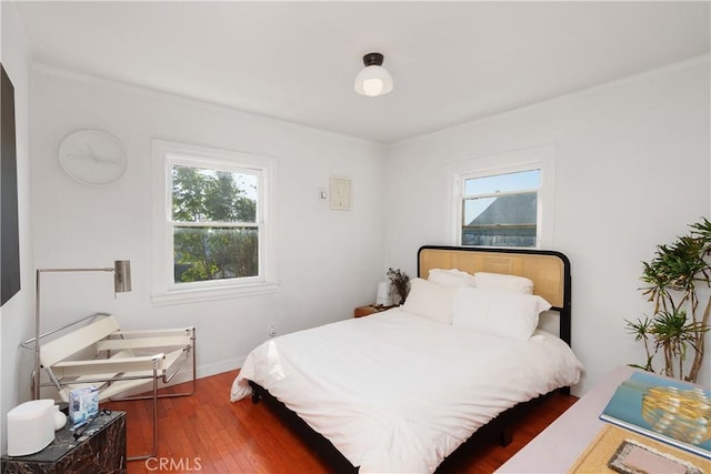 bedroom with hardwood / wood-style flooring and multiple windows