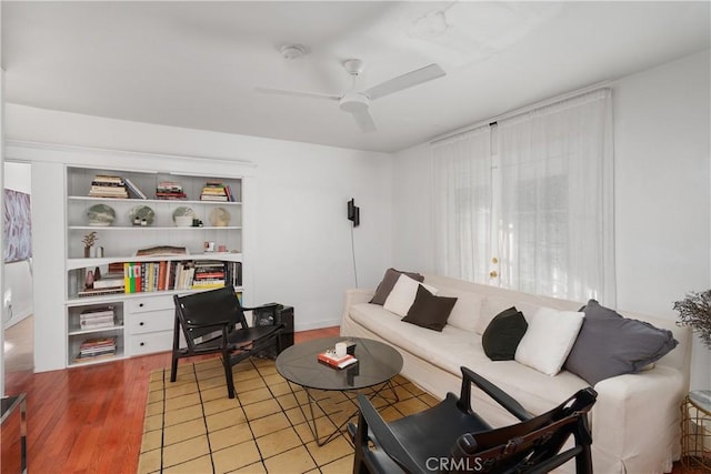 living room with ceiling fan and light hardwood / wood-style floors