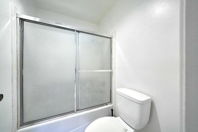 bathroom featuring toilet and enclosed tub / shower combo