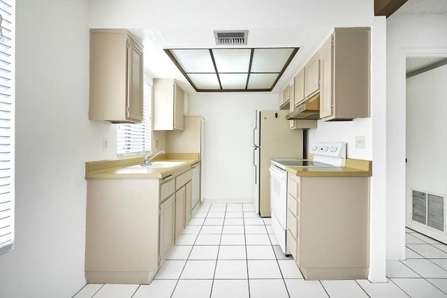 kitchen with sink, white appliances, light tile patterned flooring, and light brown cabinetry