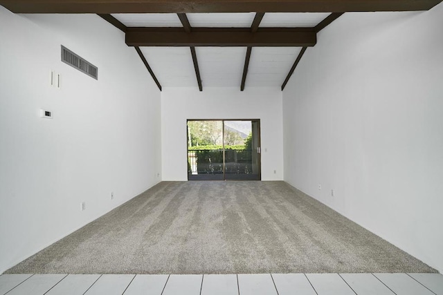 unfurnished living room featuring beam ceiling, light colored carpet, and high vaulted ceiling