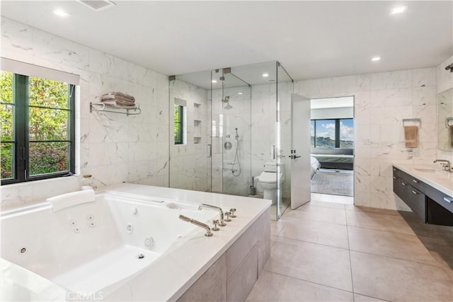 full bathroom with tile patterned flooring, vanity, tile walls, and toilet