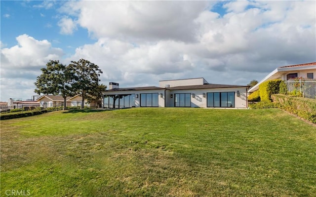 rear view of house with a yard